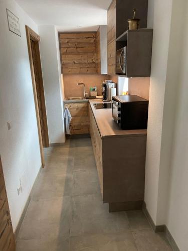 a small kitchen with a sink and a counter at Haus Bergliebe in Winkl Reichenau