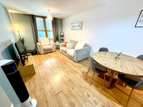 a living room with a table and a couch at Harbourside Apartment in Bristol in Bristol
