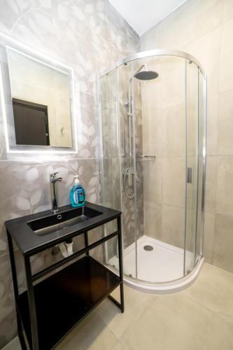 a bathroom with a glass shower and a sink at New Luxury 2 Single Bed Studio Apartment- BV3 in St Paul's Bay
