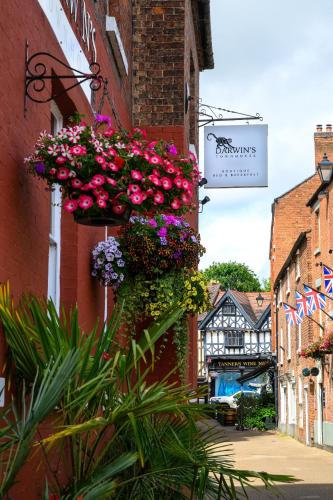 a bunch of flowers hanging from the side of a building at Darwins Townhouse in Shrewsbury