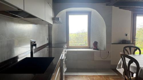 a kitchen with a sink and a window at Etxetxobarri, caserío independiente con vistas a la crestería de Anboto in Eguia