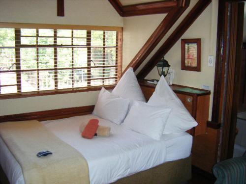 A bed or beds in a room at Tudor Lodge Guest House