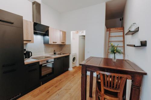 a kitchen with a wooden table and a wooden floor at Apartments Fleischhauerstraße in Lübeck
