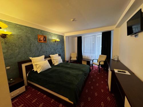 a hotel room with a bed and a television at Princess Butique in Poiana Brasov