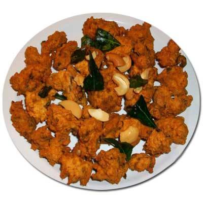 a plate of food on a white plate at Dhanunjayas Luxury Hotel in Hosūr