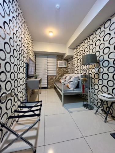 a bedroom with a bed and a table and chairs at The Monroe at Horizons 101 in Cebu City