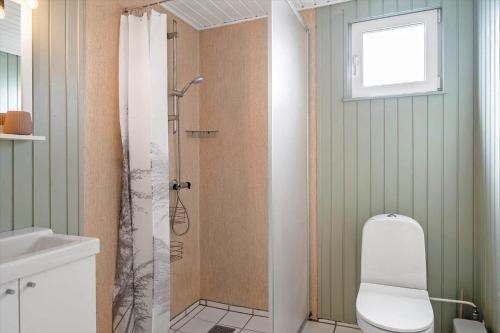 a bathroom with a shower with a toilet and a sink at 905-Thisted-Kobbelsti-73 in Torsted