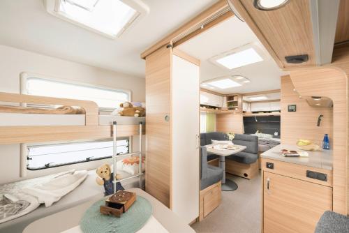 a room with a bunk bed and a desk at Camping Resort Bayerwald in Waldkirchen