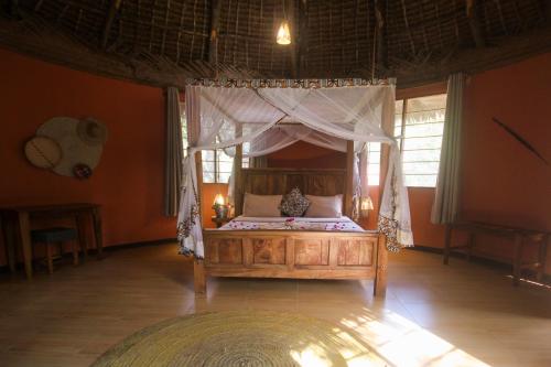 a bedroom with a bed with a canopy at Africa Safari Selous Nyerere national park in Nyakisiku
