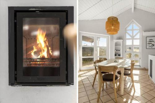 a living room with a fireplace and a dining room table at 984-Thisted-Astien-4 in Torsted