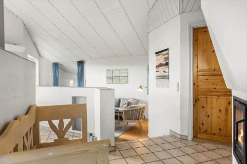 a living room with a table and a wooden door at 984-Thisted-Astien-4 in Torsted