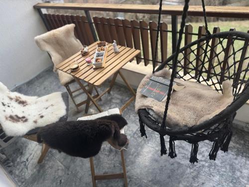 a room with a table and a chair and a table and a bird at Boris’s Guest Apartment in Chepelare