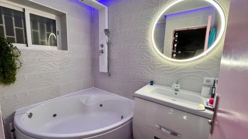 a white bathroom with a tub and a sink at Ocean Soul Apartment in Santa Cruz de Tenerife