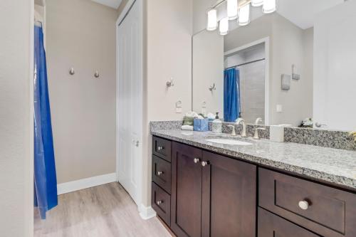 a bathroom with a sink and a large mirror at Luxury Oasis - Fresh impovements, Pool & Patio in Cape Coral