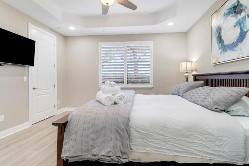 a bedroom with a large bed and a flat screen tv at Luxury Oasis - Fresh impovements, Pool & Patio in Cape Coral