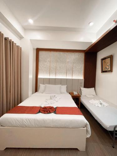a bedroom with two beds in a room at The Lumber Hotel and Resort in Virac