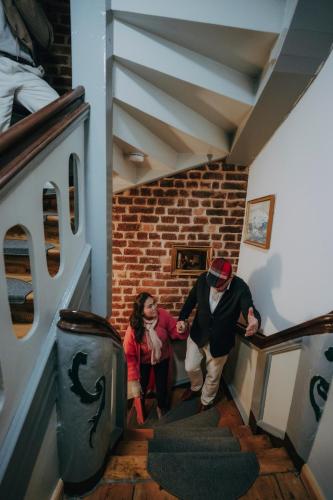 two people walking down a staircase in a building at Apartments in der Blocksquerstraße in Lübeck