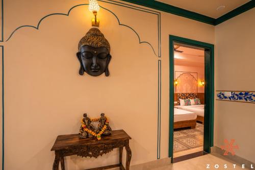 a room with a black mask on the wall at Zostel Agra in Agra