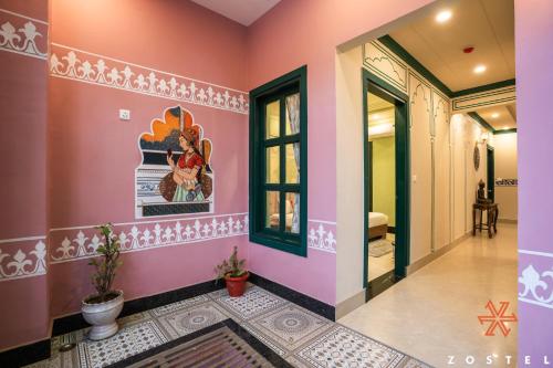 a hallway in a house with pink walls at Zostel Agra in Agra