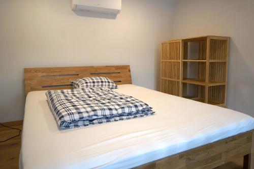 a bedroom with a bed and a book shelf at KgB - 32, Stylish City Apartment - 10 mins walk to Old Town in Vilnius