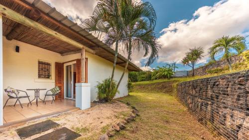 a house with a patio with a table and chairs at Shanti Ghar Guest House in Tamarin