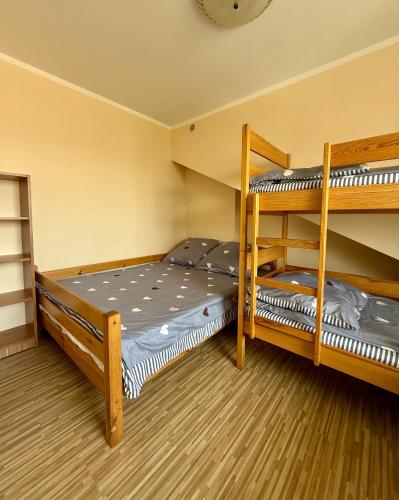 a bedroom with two bunk beds in a room at U Gosa in Ustronie Morskie