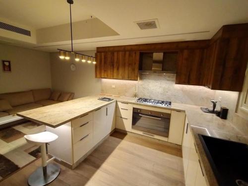 a kitchen with wooden cabinets and a counter top at فيلا فندقية بالشيخ زايد - Zayed Suites B in Sheikh Zayed