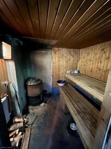 a room with a wooden bench in a room at Lake house 56 km from Helsinki in Lohja