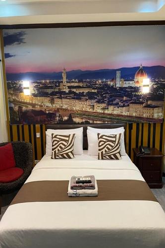 a bedroom with a bed with a view of a city at Angeles Palace Hotel in Angeles