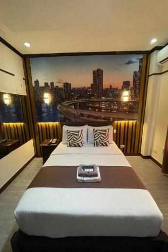 a bedroom with a large bed with a view of a city at Angeles Palace Hotel in Angeles