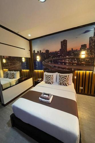 a bedroom with a bed and a view of a city at Angeles Palace Hotel in Angeles
