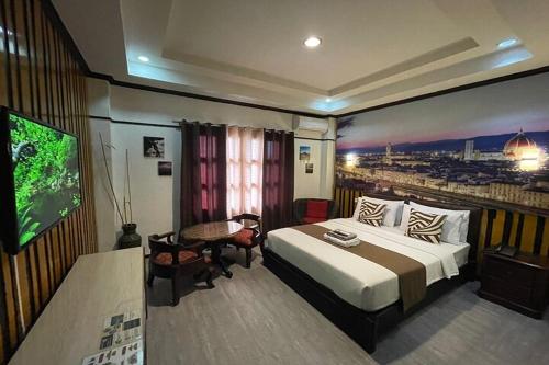 a hotel room with a bed and a flat screen tv at Angeles Palace Hotel in Angeles