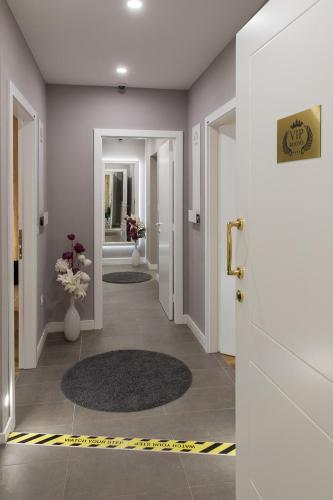 a hallway with two doors and two rugs at VIP Rooms in Split
