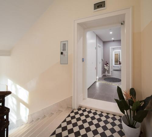 a hallway with a black and white checkered floor at VIP Rooms in Split
