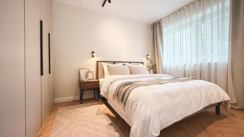 a bedroom with a large bed and a window at Riia street apartment with parking in Tartu