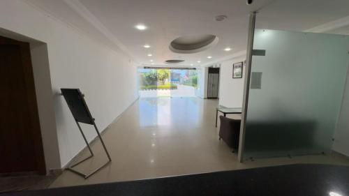 an empty room with a mirror and a hallway at The Aana Hotel Sohna -Gurgaon Road in Gurgaon