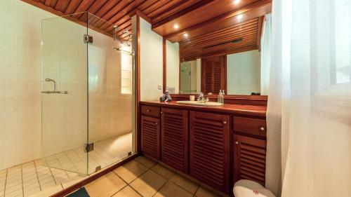 a bathroom with a sink and a shower at Shanti Ghar Guest House in Tamarin