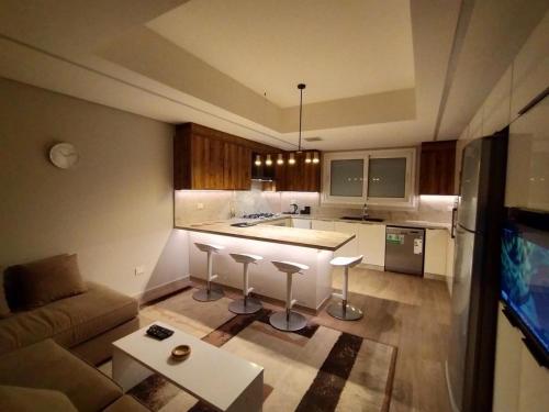 a kitchen with a couch and a table in a room at فيلا فندقية بالشيخ زايد - Zayed Suites B in Sheikh Zayed