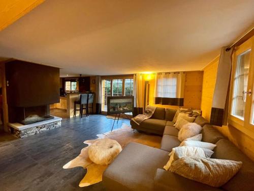 a living room with a couch and a fireplace at Charming Chalet With Splendid Views Near Gstaad in Lauenen
