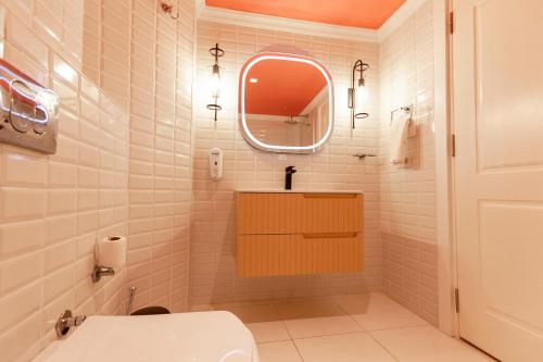 a bathroom with a toilet and a mirror at Kalkan Suite 102 in Kas