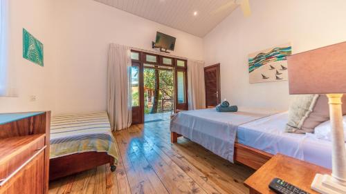 a bedroom with a bed and a desk at Shanti Ghar Guest House in Tamarin