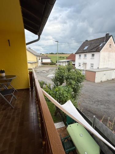a balcony with a surfboard on the side of a house at Das kleine Vulkanhaus in Daun
