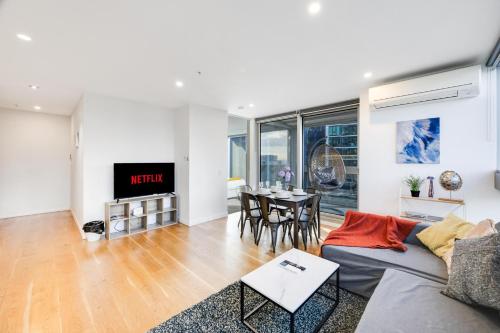 a living room with a couch and a table at Nest Apartments on Rose Lane in Melbourne
