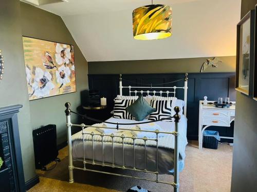 a bedroom with a bed and a desk in it at horn and trumpet in Bewdley