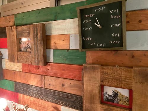 a wall of reclaimed wood with a sign on it at ふる郷荘Furusato Furano in Furano