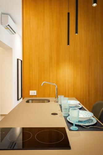 a kitchen with a sink and two glasses on a counter at Capo D'Amuri in Palermo