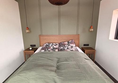 Un dormitorio con una cama grande con dos mesitas de noche. en Valey Luxury - Icelandic Countryside Escape, en Hvammstangi