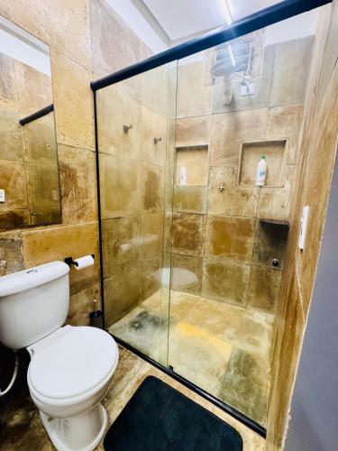 a bathroom with a toilet and a shower at Enigma Casa Preá in Cruz