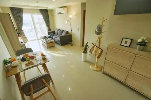 a living room with a table and a couch at The Two bedrooms Two bathrooms in Phuket Old Town in Phuket