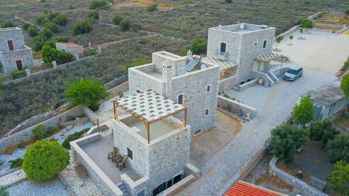 an aerial view of a large white building at Armenopetra View Gerolimenas in Gerolimenas